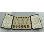 A cased set of twelve silver gilt and enamelled tea or coffee spoons,