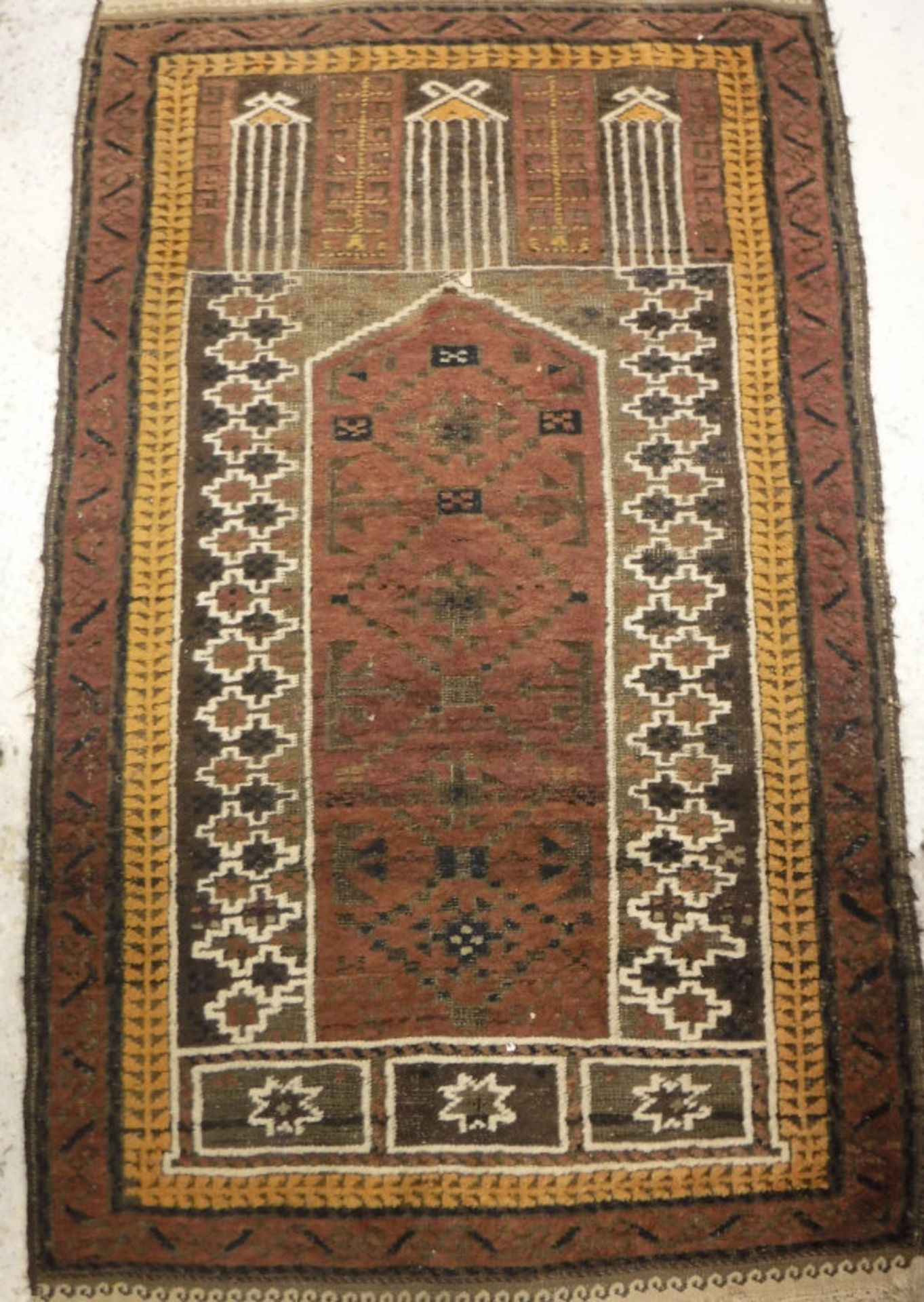 A Turkish prayer rug, the central panel set with pillar design on a brown ground, - Bild 2 aus 2
