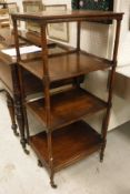 A 19th Century mahogany four tier whatnot with simulated bamboo supports,