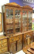 A pair of 19th Century mahogany bookcase cabinets with glazed and bared cabinet doors over drawers,