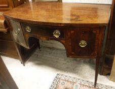 A George III mahogany bow front sideboard, the plain top above one narrow and two deep drawers,