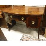 A George III mahogany bow front sideboard, the plain top above one narrow and two deep drawers,