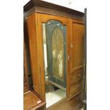 An Edwardian mahogany wardrobe compactum with single mirrored cupboard door and three further