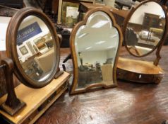 An early 19th Century mahogany toilet mirror, the oval plate on a three drawer base,