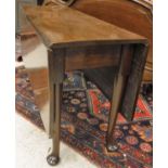 A late George III mahogany rectangular drop leaf dining table on turned tapering legs to pad feet