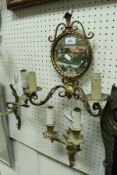 Three mirrored wall sconces and two pairs of cast brass Rococo style wall lights in the Louis XV