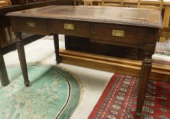 An India Jane teak three drawer writing table with faux crocodile skin cover