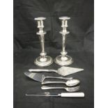 A pair of modern plated candlesticks in the classical taste together with a canteen containing