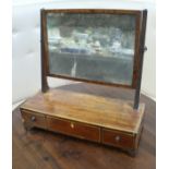 A Regency mahogany toilet mirror with rectangular plate on a three drawer base