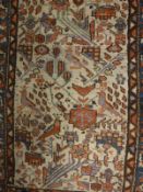 A Caucasian rug, the central panel set with stylised bird and foliate decoration on a grey ground,