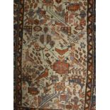 A Caucasian rug, the central panel set with stylised bird and foliate decoration on a grey ground,