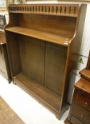 A mahogany bookcase with galleried top to integral shelf with three adjustable shelves to bracket