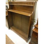 A mahogany bookcase with galleried top to integral shelf with three adjustable shelves to bracket