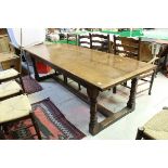 A large oak refectory style dining table with turned legs to stretchered base,