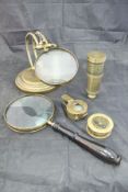 A brass framed table magnifying glass, a brass cased compass with magnifying glass,