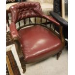 A Victorian walnut framed salon chair with red leather upholstery on turned and ringed supports to