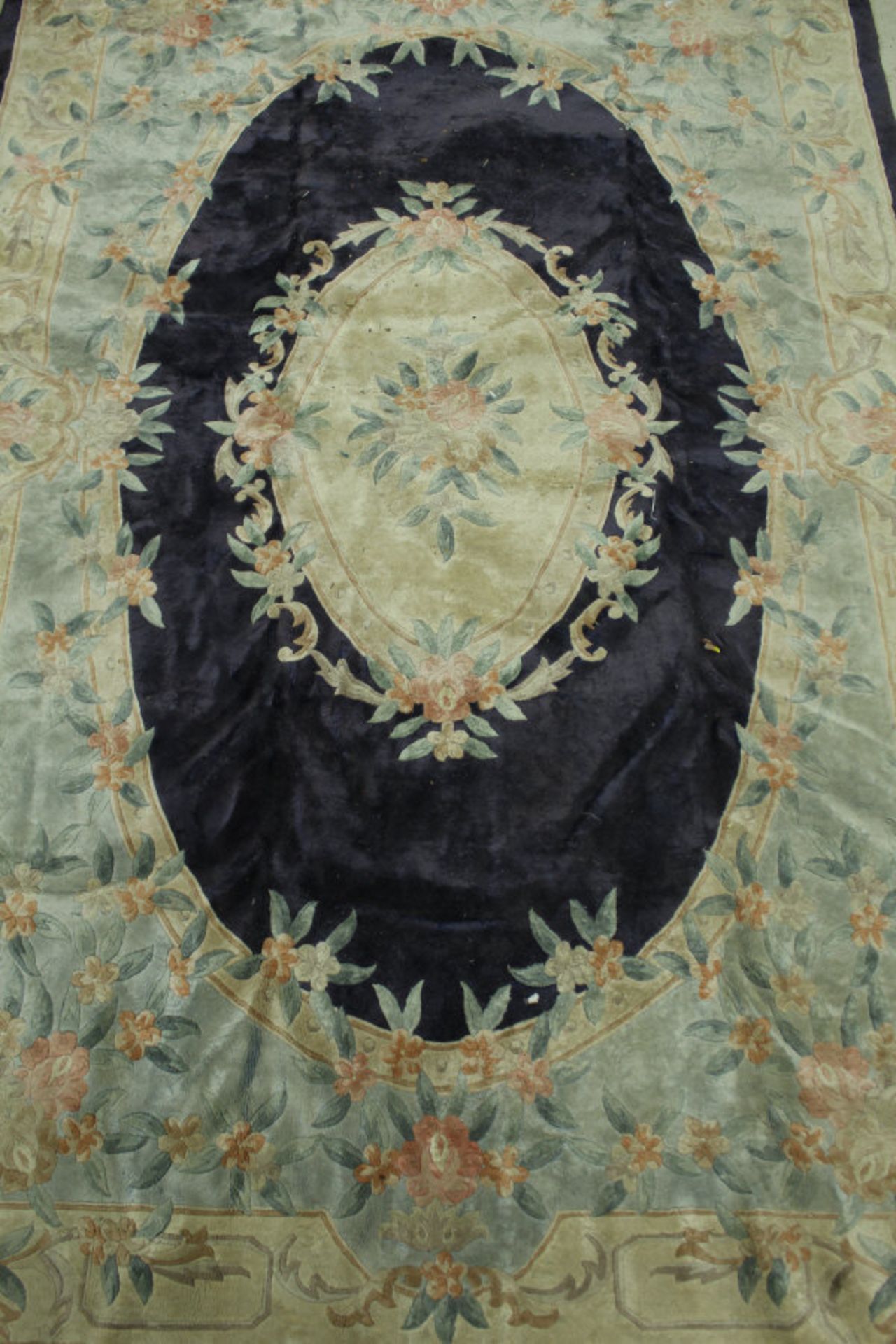 A Chinese silk rug, the central panel set with floral decorated medallion on a blue ground, - Bild 2 aus 2