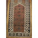 A Turkish prayer rug, the central panel set with pillar design on a brown ground,