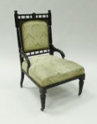 A Victorian ebonised salon chair in the manner of Godwin,