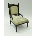 A Victorian ebonised salon chair in the manner of Godwin,