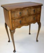 An early 20th Century walnut two drawer chest on cabriole legs