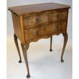 An early 20th Century walnut two drawer chest on cabriole legs