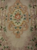 A Chinese superwash rug, the central panel set with floral decorated medallion on a lilac ground,