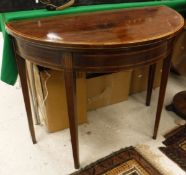 A Regency mahogany and rosewood cross-banded demi-lune card table
