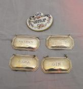 A set of four silver wine labels inscribed "Whisky", "Vodka",