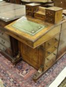 A Victorian walnut and inlaid Davenport desk with raised superstructure over a sloping fall and