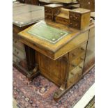 A Victorian walnut and inlaid Davenport desk with raised superstructure over a sloping fall and