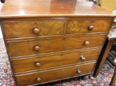 A Victorian mahogany chest of two short over three long drawers with knob handles raised on turned