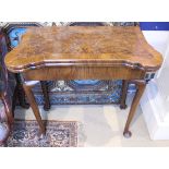 A walnut and feather-banded fold-over card table in the early 18th Century manner,