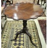 A George III mahogany tea table, the circular top with pie-crust rim,