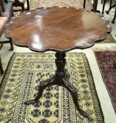 A George III mahogany tea table, the circular top with pie-crust rim,