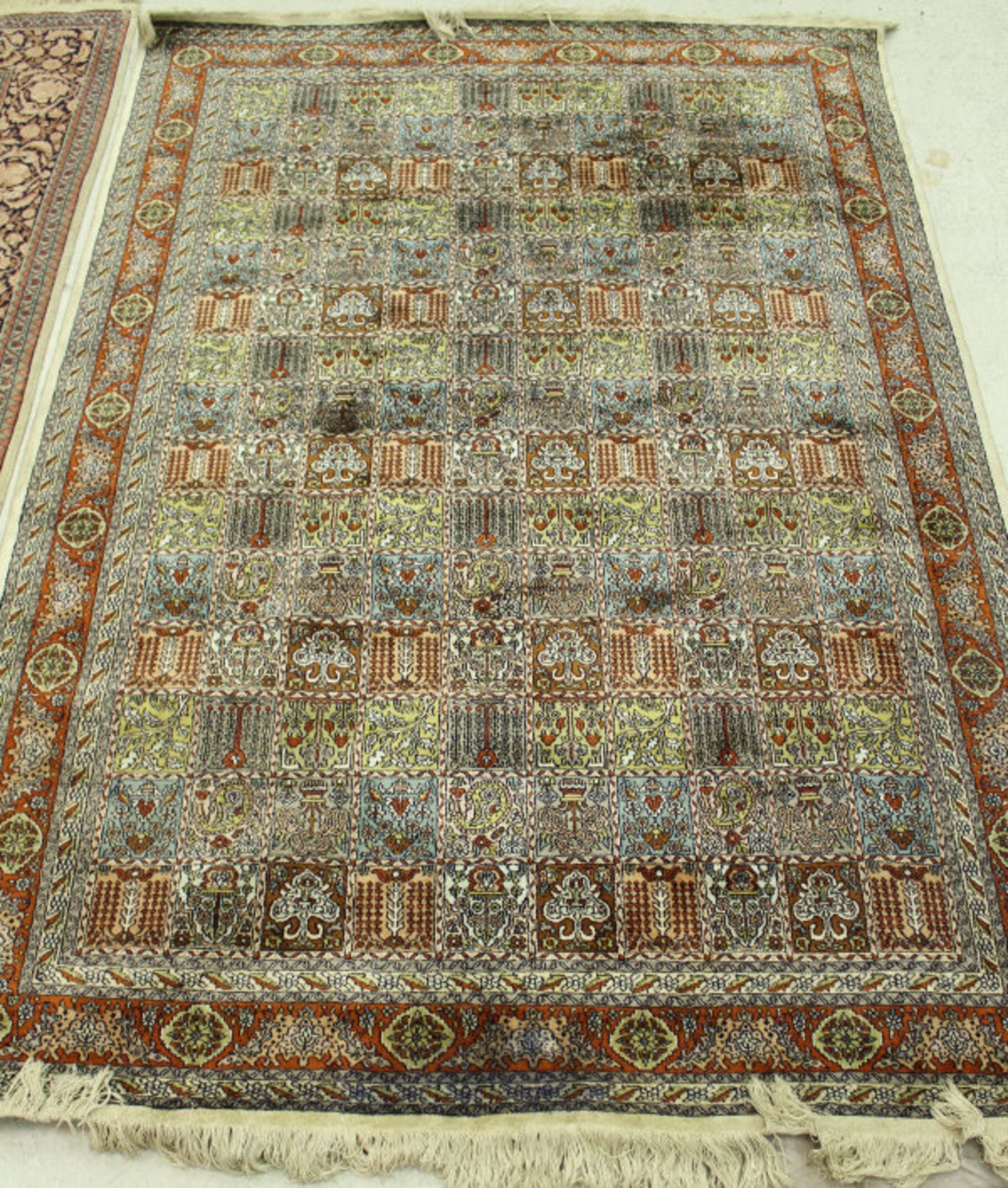 A Persian carpet, the central panel set with repeating tiled pattern, - Image 2 of 2