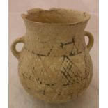 An ancient near Eastern pottery buffware two handled jar with geometric design flanked by two plain