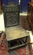 A set of three 19th Century carved oak panel seated hall chairs the backs decorated with flowers in
