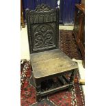 A set of three 19th Century carved oak panel seated hall chairs the backs decorated with flowers in