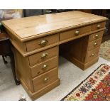 A Victorian waxed pine desk with three frieze drawers on two pedestals of three drawers,