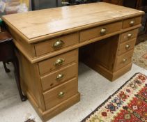 A Victorian waxed pine desk with three frieze drawers on two pedestals of three drawers,