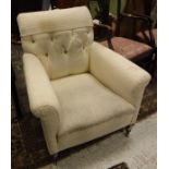 A button back cream upholstered armchair