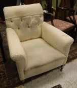 A button back cream upholstered armchair
