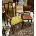 A set of four Victorian style leather dining chairs with spindle and studded backs and seats to