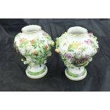 A pair of Carl Thieme Potschappel vases of pear form with floral encrusted decoration enclosing
