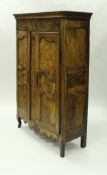 An 18th Century French walnut and burr panelled armoire in the Louis XV Provincial taste,