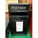 A black painted cast metal postbox inscribed "Postbox"