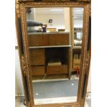 A reproduction gilt and painted mirror