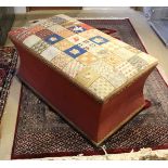 A Victorian upholstered box ottoman with needlework decorated seat over waisted sides on squat bun