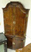 A walnut free-standing corner cupboard in the early 18th Century manner,